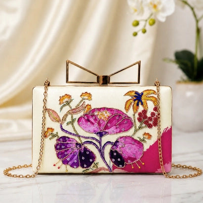 Blooming Orchid Printed Highlight Clutch with orchid-inspired floral artwork, printed highlights, gold chain strap, and premium clasp.