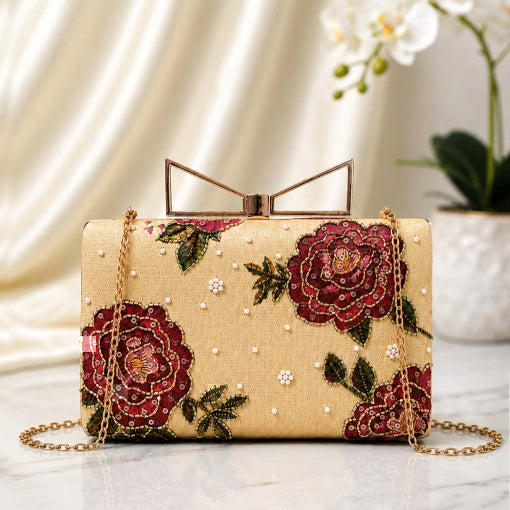 Burgundy Rose Printed Highlight Clutch with elegant burgundy rose floral artwork on a beige base, gold-tone frame clasp, detachable chain, and premium designer finish.