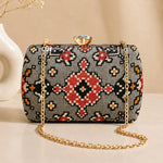 Stone Mosaic Clutch with grey mosaic-inspired woven pattern, gold chain strap, and crystal clasp