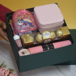 The Blush Bloom Hamper featuring a premium jewellery storage case, unicorn pouch, body mist, nail polish, Ferrero Rocher chocolates, floral accents, and a luxury gift box by YelloWraps.