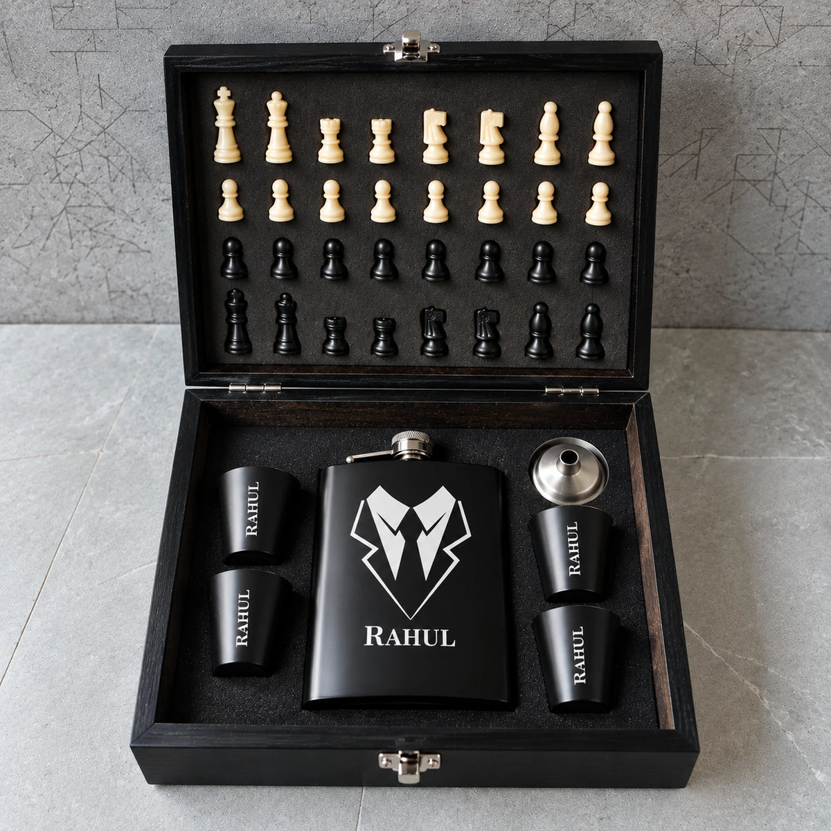 The Classic Gentleman Chess Gift Set featuring a personalized black flask, matching shot glasses and chess set arranged in a premium wooden presentation box.