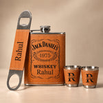 Personalized whiskey flask with two matching shot glasses and bottle opener displayed together