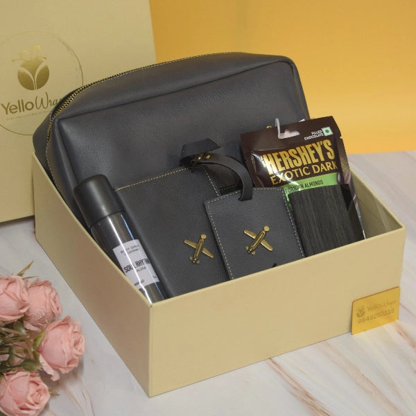 The Executive Explorer Hamper featuring a premium travel pouch, personalized passport cover, luggage tag, card holder, perfume, Hershey's Exotic Dark chocolates, and luxury gift packaging by YelloWraps.