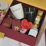 The Forever Together Hamper featuring Hubby and Wifey ceramic mugs, personalized Mr. & Mrs. luggage tags, Ferrero Rocher chocolates, lemon and lavender bath salt, decorative rose, and premium luxury gift packaging by YelloWraps.