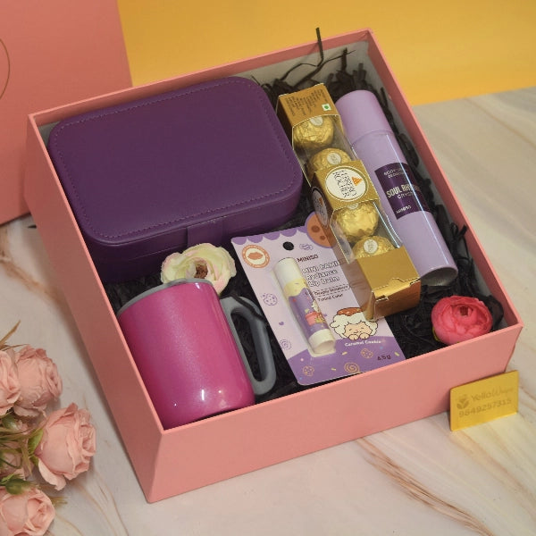 The Lavender Luxe Hamper featuring a premium jewellery organizer, mini storage pouch, body mist, nail polish, Ferrero Rocher chocolates, decorative floral accents, and elegant luxury gift packaging by YelloWraps.