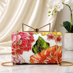 Tropical Blossom Printed Highlight Clutch featuring vibrant tropical floral prints in coral, pink, and orange, gold frame clasp, detachable chain, and premium evening bag design.