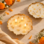 Elegant golden wax urli with white wax and gold flakes, styled with marigold flowers and festive décor.