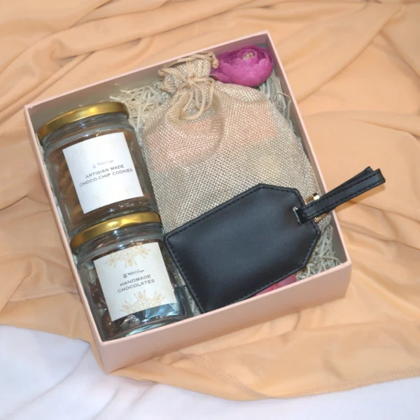 Refreshment Hamper consists of cookies, chcolates, tea sachets along with lugguage tag best employye gifts