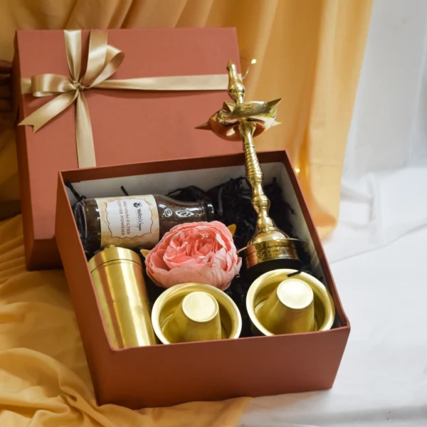 Traditional brass coffee dabara set with tumbler, authentic filter coffee powder, and brass diya for housewarming gift. Golden Heritage Home Gift