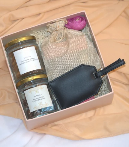 Refreshment Hamper consists of cookies, chcolates, tea sachets along with lugguage tag best employye gifts